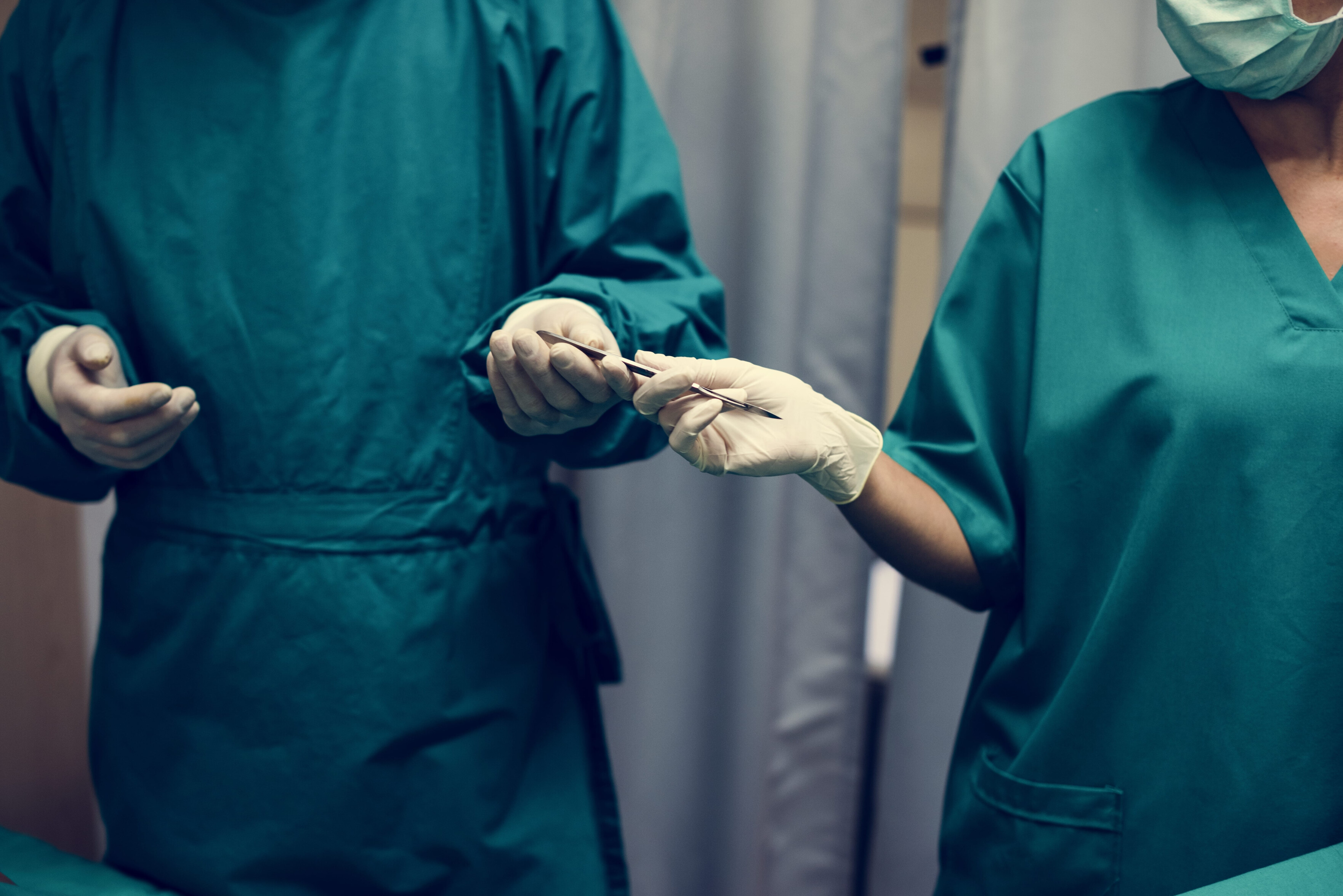 Surgeons passing a scalpel